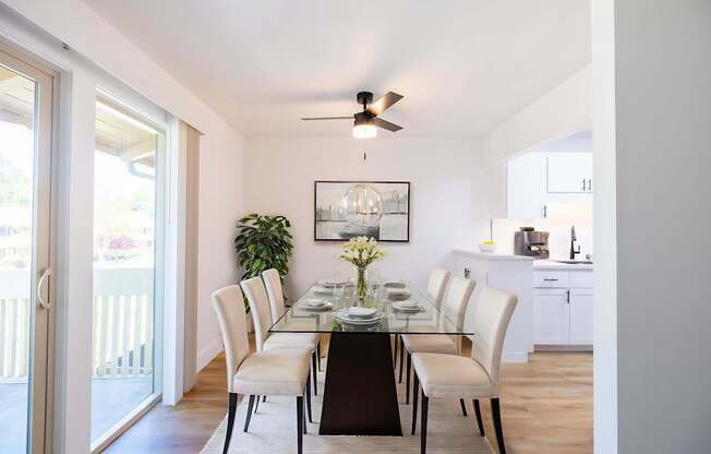 A dining room with a table set for six.