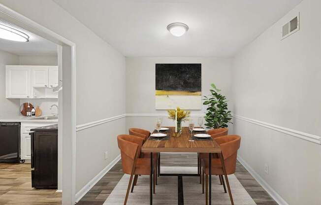 A dining room with a wooden table and chairs.
