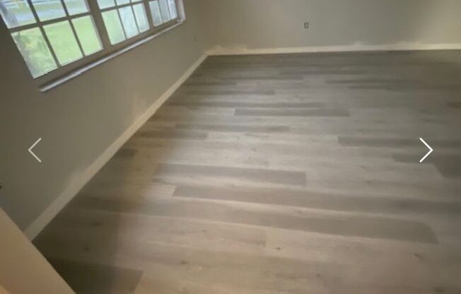 Available NOW! NEW FLOORS AND PAINT! Lovely 3/2 in Poinciana! HUGE fenced yard and NO CARPET!