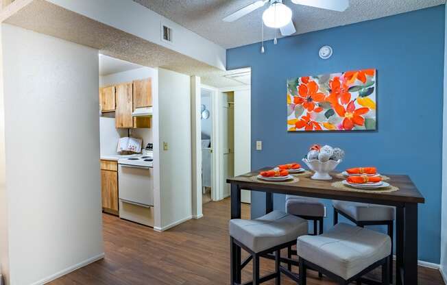 a dining room and kitchen with a table and chairs