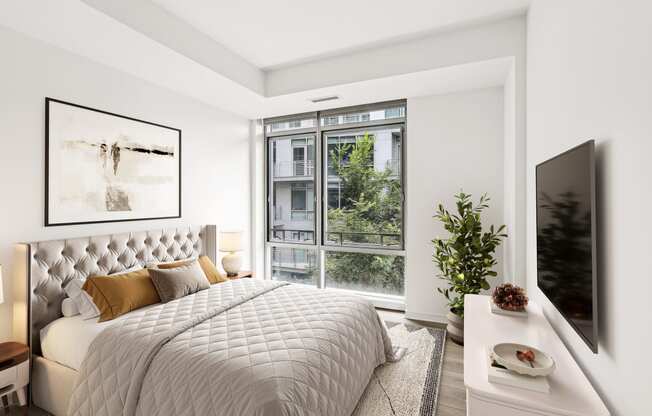 a bedroom with a bed and a large window