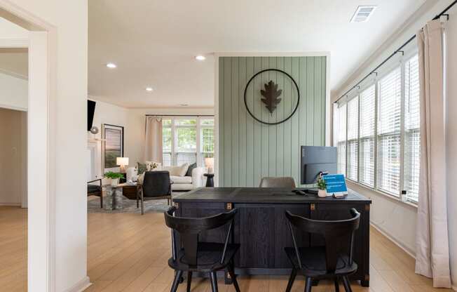 a home office with a desk and chairs