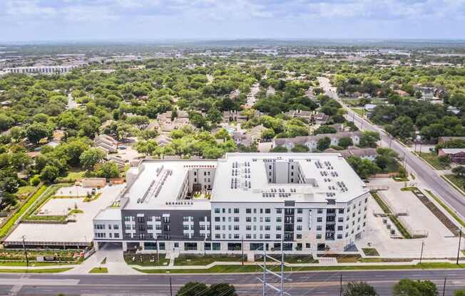 A large white building with a parking lot in front of it.
