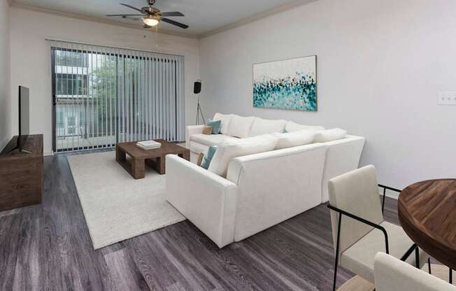 The Hendrix Apartments a living room with a white couch and a table at The Hendrix, Georgia