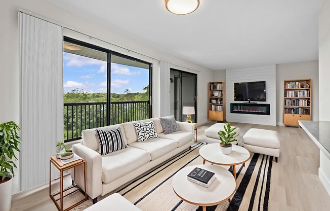 A living room with a white couch and a coffee table.