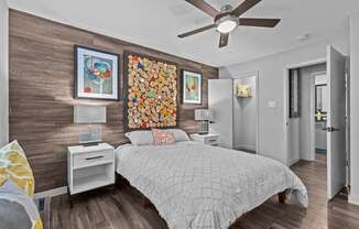 a bedroom with a bed and a ceiling fan