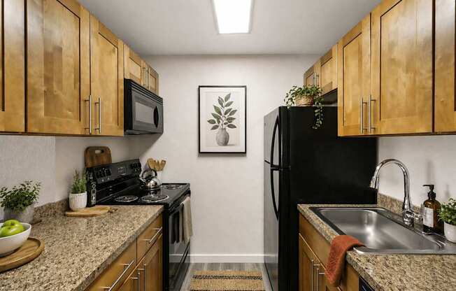A kitchen with wooden cabinets and a black refrigerator.