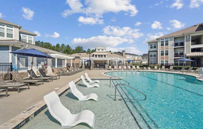 our resort style swimming pool is next to our building with lounge chairs