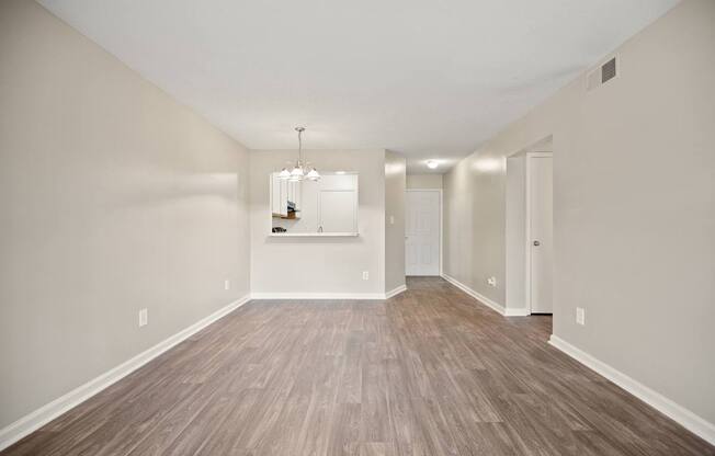 A room with wooden floors and a chandelier.