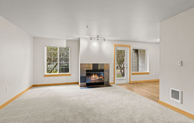 A living room with a fireplace and a carpet.