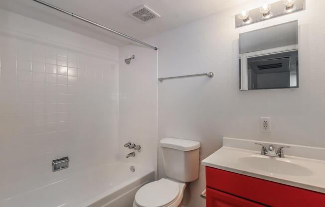 a white sink sitting under a mirror