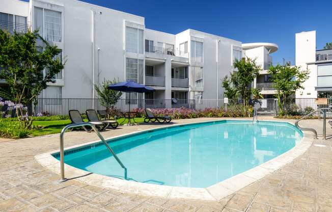 a swimming pool in front of an apartment building