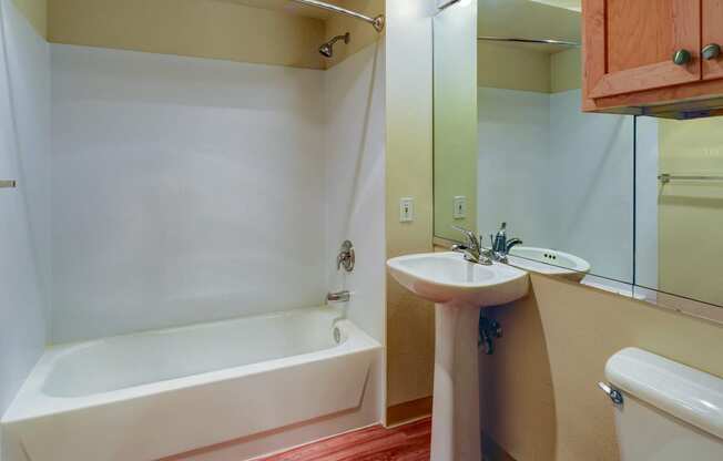 a bathroom with a toilet sink and a bath tub