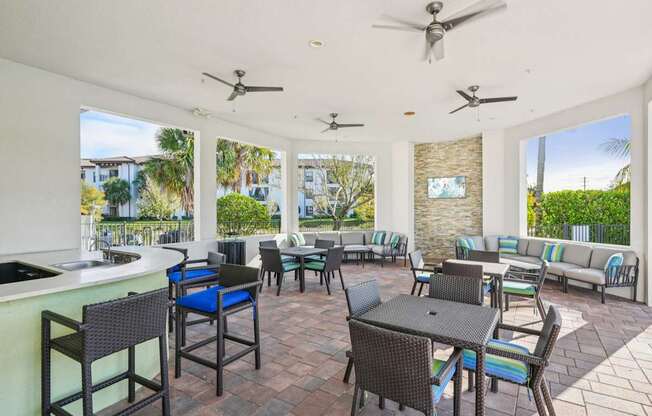 A patio with a table and chairs and a bar area.