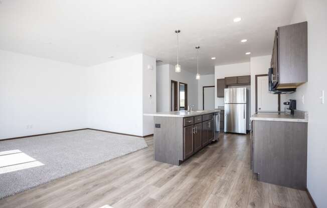 a kitchen and living room with wood flooring and