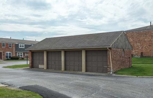 A garage with a brick wall and a grey roof.