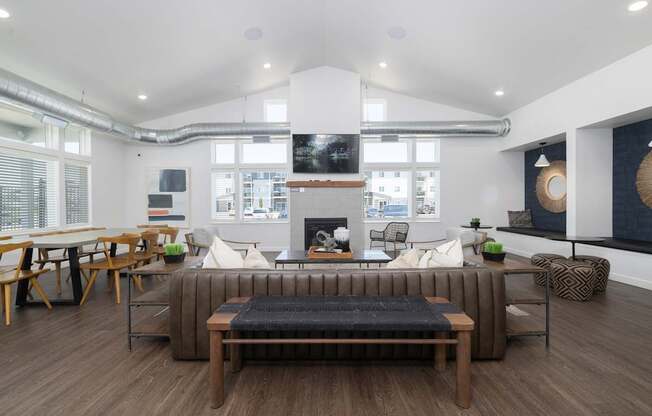 A modern living room with a fireplace and a large sectional sofa.