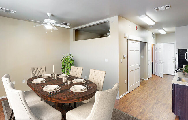 A dining room with a round table set for six.
