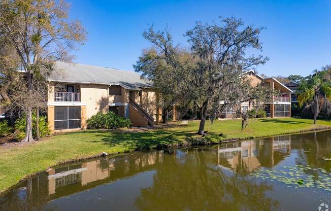 A house with a pond in front of it.