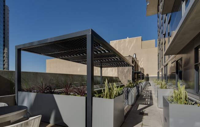 a pergola on a patio in front of a building