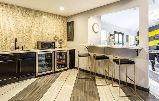 a kitchen with a counter with three stools at The Hub at Baton Rouge, Baton Rouge, LA 70808