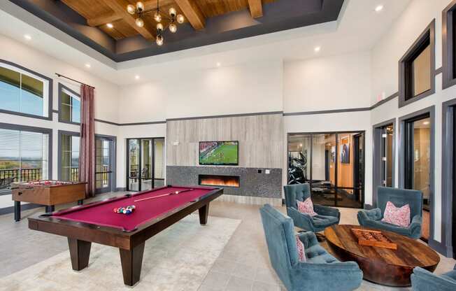 a game room with a pool table and a tv