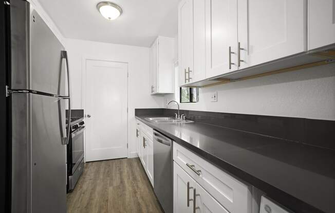 Apartments in Sherman Oaks for Rent - Brody Terrace - Modern Kitchen with Stainless Steel Appliances, Black Counter Tops & White Cabinets