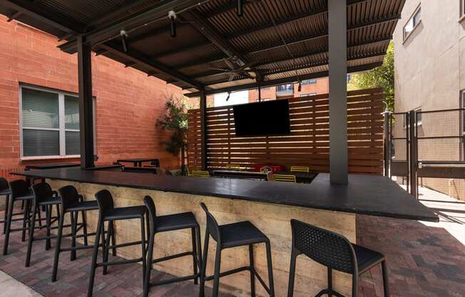 an outdoor bar with chairs in a patio