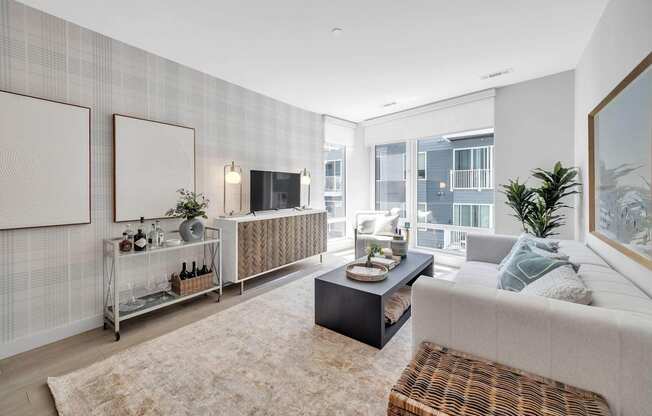 A modern living room with a large window and a balcony.