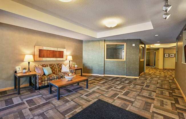 A lobby with a couch and coffee table.