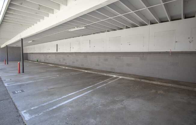 a parking garage with white walls and a concrete floor