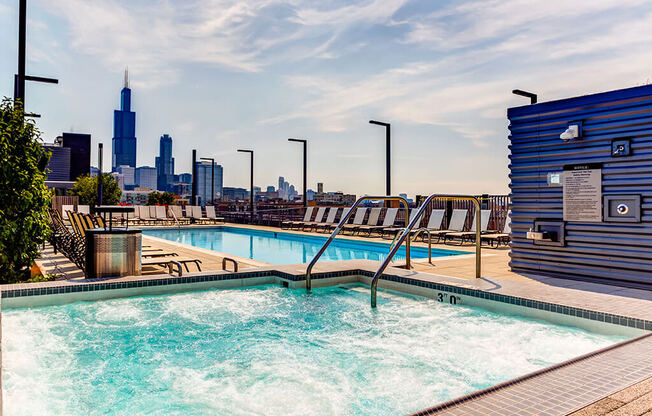 Warming rooftop spa with a hot tub, lap swimming pool and view of the Chicago skyline at The Madison at Racine, Chicago