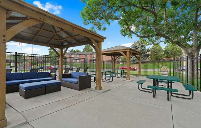 A park with a pavement, a gazebo, a bench and a table at Mountain Vista Apartments, Lakewood, 80228