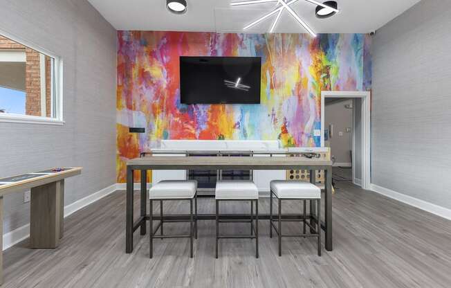 a dining room with a table and chairs and a tv