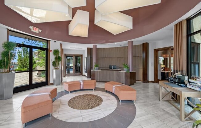 a lobby of a hotel with couches and a reception desk