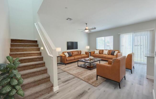 A living room with a staircase and a couch.