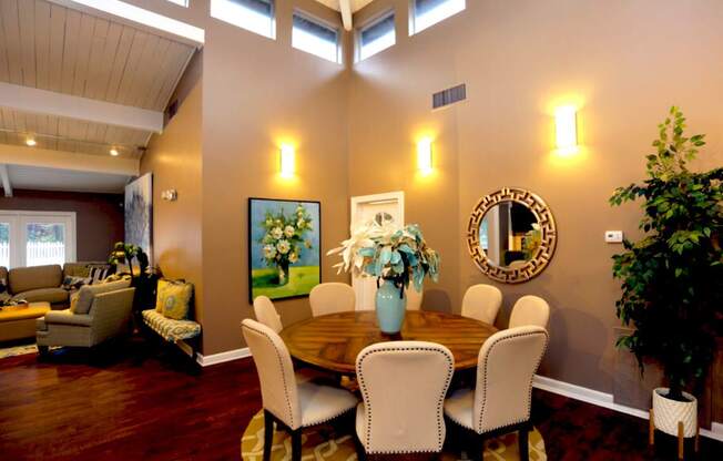 A dining room with a wooden table and chairs.