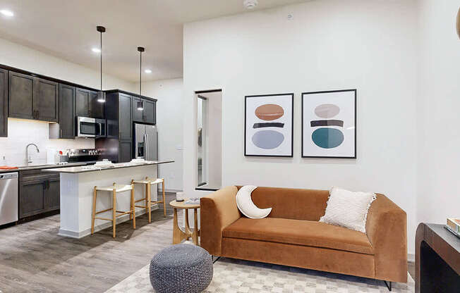 a studio apartment living room with a sofa and natural light from the window