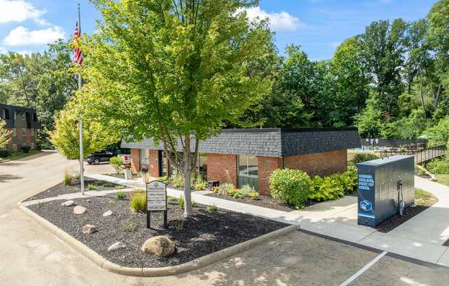 A small building with a flag on a pole in front of it.