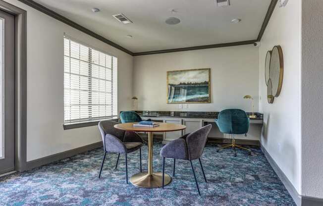 a meeting room with a table and chairs