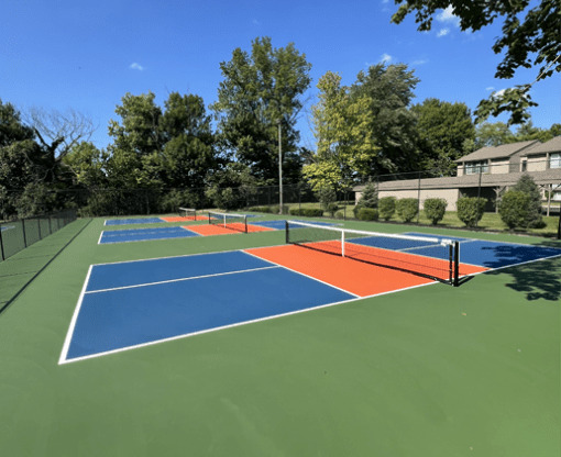 a tennis court with four different courts on it on a sunny day