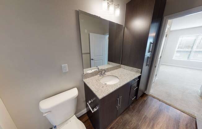 Bathroom with sink, toilet and storage cabinet