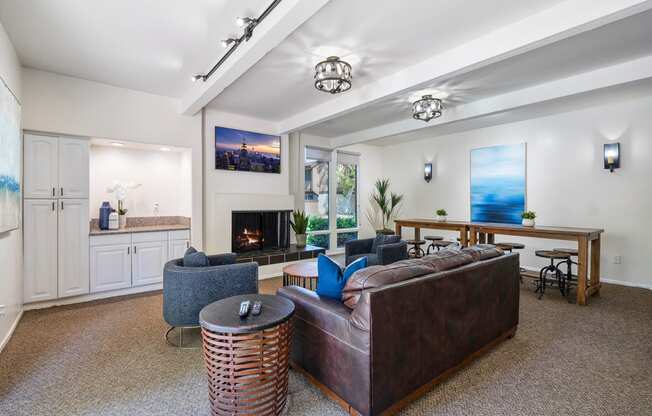 a living room with a leather couch and a fireplace