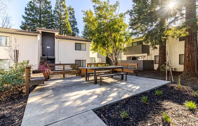 A sunny day at a modern residential area with a bench in the foreground.