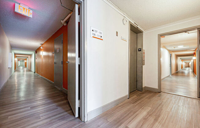 a hallway with wood floors and white walls and open doors at Citra Apartments LLC, San Diego, CA, 92107