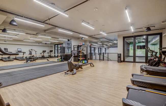 a gym with weights and yoga mats and a reformer