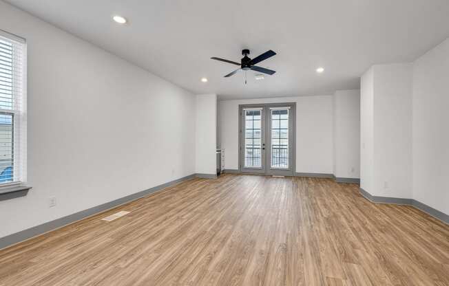 an empty living room with white walls and a ceiling fan at Meridian at CityPlace, Woodbury, 55125