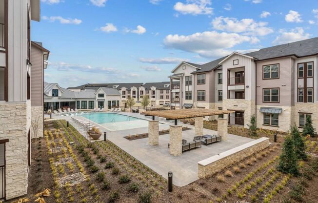 an apartment complex with a pool and a building with balconies