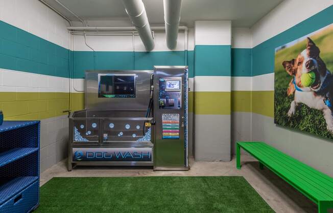 a dog wash room with a vending machine and a green bench