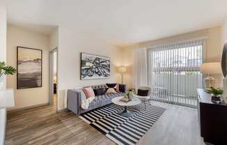 an open living room with a couch and a coffee table at Paisley and Pointe Apartments, Las Vegas, NV